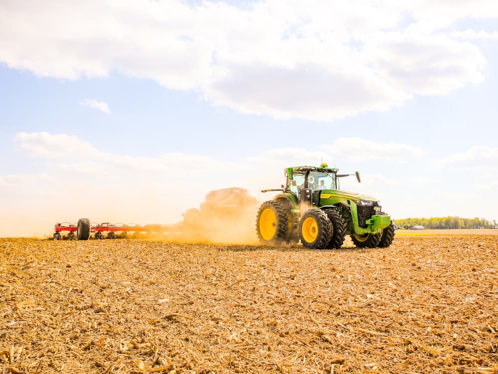 Tractor working in a field, representative of agricultural SCR diesel applications.